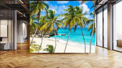 Bottom Bay, Barbados - Paradise beach on the Caribbean island of Barbados. Tropical coast with palms hanging over turquoise sea. Panoramic photo of beautiful landscape. Wall mural