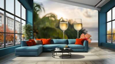 Romantic moments in summer at sunset with two glasses of white wine - Relaxing romantic holiday concept with beautiful view of tropical beach and coast Wall mural