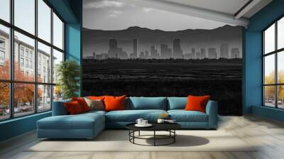 Monochrome, landscape shot of the downtown Denver, Colorado skyline, showing skyscrapers and buildings silhouetted against the backdrop of the Rocky Mountains Wall mural