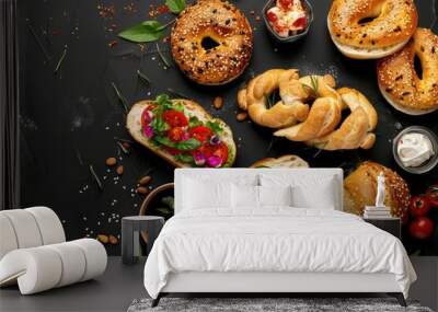 Fresh bagels topped with seeds and colorful vegetables, delicious bakery items on black background, gourmet breakfast flat lay Wall mural