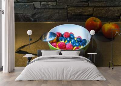 Two apples and colorful healthy fruit mix in dish Wall mural