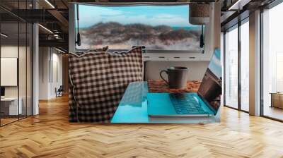 Alternative office for smart working and digital nomad vanlife lifestyle. One laptop on the camper van table with nature beach amazing beautiful view. Freedom lifestyle people. Online work business Wall mural