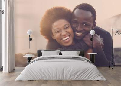 beautiful black race nice model couple man and woman young age hug and stay together with love and friendship. outdoor scenic place near the beach for vacation or lifestyle. Wall mural