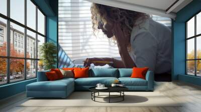 Beautiful curly woman work at laptop computer lay down on the sofa at home - conept of free people from usual office and alternative digital nomad or house workers - technology device Wall mural