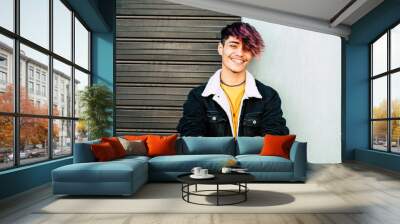 Cheerful portrait of caucasian young man teenager smiling at the camera - two colors background gray and white - urban people style having fun in outdoor Wall mural