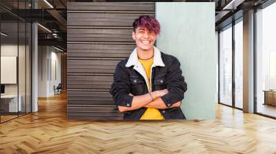 Cheerful young happy boy teenager hispanic race smile and laugh in front of the camera in posed portrait - two colors background urban style - youth teenager enjoy - violet diversity hair Wall mural