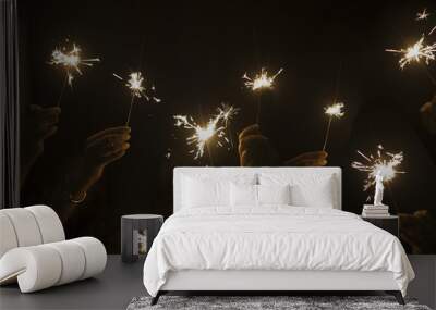 dark night celebrate concept with lot of hands taking and using light sparkles fire together. have fun for new year eve or party. companionship and friendship during celebration. happy lifestyle Wall mural