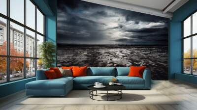 Dramatic cloudscape and flood beach in dark night weather. Stormy and rainy sky with ocean in background. Epic seascape with white sunset light and black clouds. Wall mural