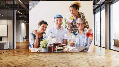 Family and friends at lunch all together at home in the terrace - eating and drinking food and beverages - smile and having fun- friendship with mixed ages senior and middle age people Wall mural