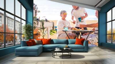 grandfathers adult mature and teenager nephew enjoy outdoor in the terrace some leisure with food and drinks. ocean and city view, vacation sunny day nice weather concept and background. happy people Wall mural