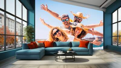 Group of happy adult friends enjoy and celebrate together the summer holiday vacation travel leisure acitivity - men and women smiling and having fun with ocean in background - joyful couples Wall mural