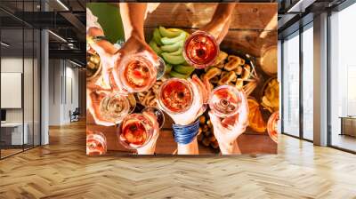 Group of happy people toasting  together with cups of red wine under the sun light in a sunny day - outdoor leisure activity for women having fun with drinks - wine and winery concept Wall mural