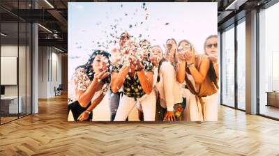 Happiness and joyful concept - group of happy women people celebrate. all together blowing confetti and having fun - new year eve and party event for group of beautiful girls -white clear  background Wall mural