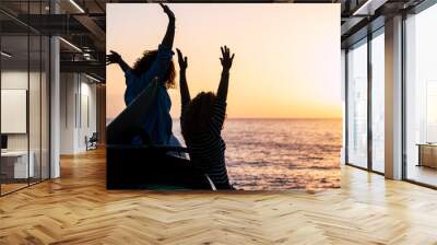 Happiness and successful concept with couple of women young friends enjoy the sunset on holiday summer vacation - joyful and people in outdoor travel leisure activity - ocean and sun background Wall mural