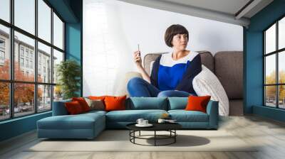 nice young woman at home with mobile phone Wall mural