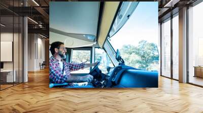 One man driving camper van and enjoying transport road trip travel activity alone. Inside view of motor home and traveling fo holiday vacation concept lifestyle people. Male driver on camper Wall mural