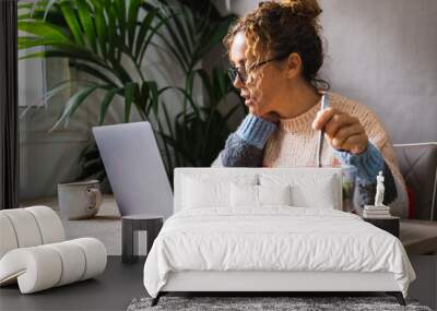 People eating fast and healthy in front of a computer during job lunch break. Modern business lifestyle working at home. One woman eat salads from transparent bowl and use notebook pc on the table Wall mural