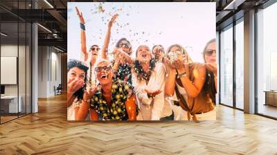 People having fun in party celebration friends concept - group of young and adult women all together laughing blowing coloured confetti - friendship and love for lifestyle with mixed active generation Wall mural