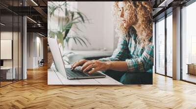 People working on computer at home. One woman write and use laptop with internet online connection. Modern female use notebook and work. Indoor leisure activity and technology. Searching on web Wall mural