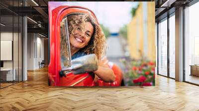 Portrait of cheerful happy adult pretty woman smile and enjoy driving car - caucasian female have fun outside the window of her vehicle - garden and road in background - people driving Wall mural