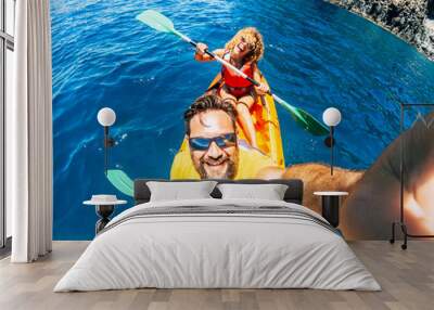 Selfie couple with top vertical point of view - happy active adult people enjoy kayak at the ocean - summer tourist in holiday vacation lifestyle - action camera and cheerful man and woman Wall mural