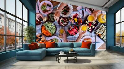 Top vertical view of table full of food and drinks and happy people friends celebrating and. enjoy together eating and having fun - concept of social distance  at home with parents in friendship Wall mural