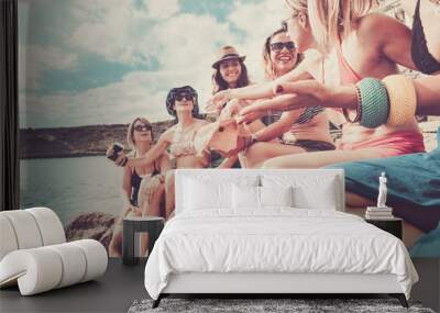 vintage filter for group of beautiful young ladies at the rocky beach taking sun near the ocean and stay in leisure all together with nice lifestyle and season summer time. friendship people Wall mural