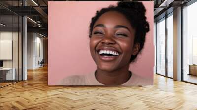 Close-Up Portrait of a Young Black Woman Laughing in Neutral Outfit Wall mural