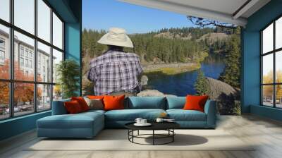 Older male hiker with sun hat overlooking the Spokane River Wall mural