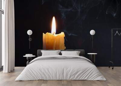 Candle flame burning on black background. Melted wax Wall mural