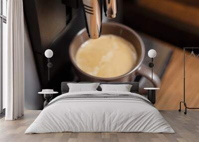 Espresso machine pouring coffee in brown cup. Wall mural