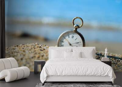 Sands of time. Antique pocket watch lost in the sand on the beach. Wall mural