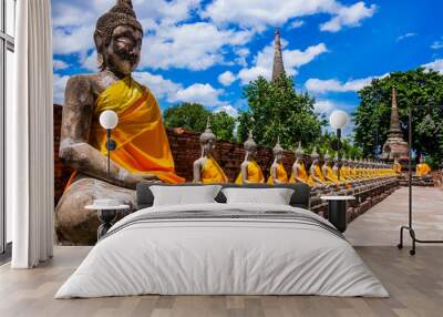 Thailand, row of Buddha images in Ayutthaya old Temple Wall mural