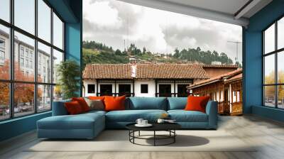 Wrought-wood balconies in front of the main square of Cusco (Peru) with hills in the background Wall mural