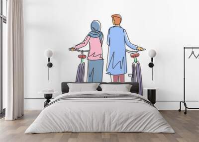 Single continuous line drawing rear view couple Arab man and woman walking together with bicycle. Young boy and girl in love. Happy romantic married couple. Dynamic one line draw graphic design vector Wall mural