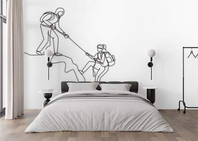 single continuous line drawing two women hikers climbing up mountain and helping to each other with  Wall mural