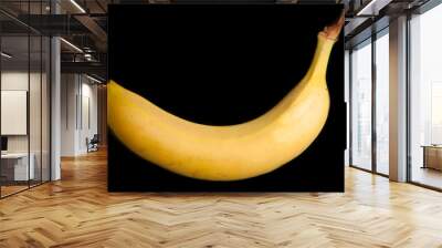 A banana on a black background Wall mural