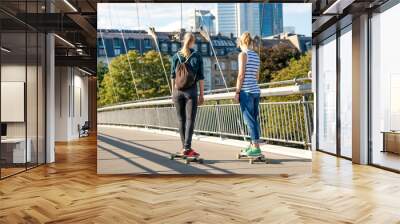 Zwei junge Frauen auf Skateboards  Wall mural