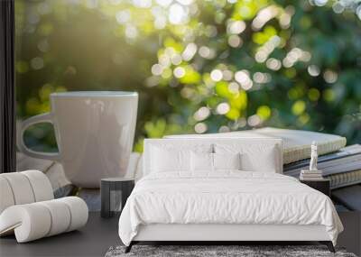 07231249 148. Close-up of a white coffee cup with a pile of notebooks on a wooden table outdoors, capturing the serene and peaceful atmosphere with natural light Wall mural