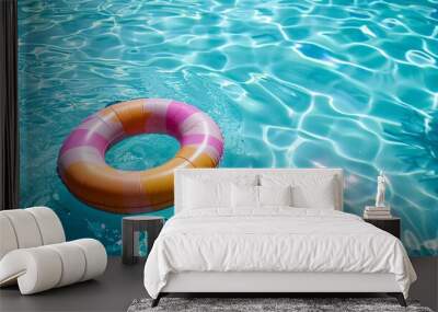 07250736 216. A vibrant inflatable ring floating on the crystal-clear blue water of a swimming pool, with the sunlight reflecting off the water, creating a perfect scene of a summer vacation Wall mural