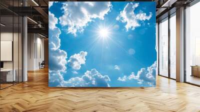 1. High-resolution image of a clear blue sky adorned with fluffy white clouds on a bright sunny summer day, capturing the serene beauty and vibrant colors of the season Wall mural