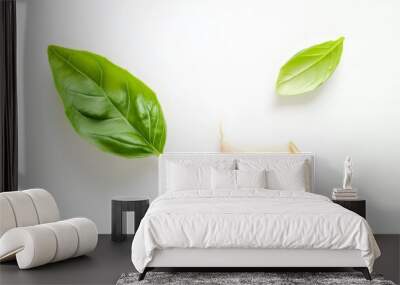 10. Top view of a single garlic clove and a basil leaf, perfectly isolated on a clean white background, highlighting their natural forms and vibrant green Wall mural