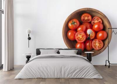 34. Top view of fresh cherry tomatoes, with a few halves, in a wooden bowl, isolated on a bright white background, highlighting their vibrant red color and natural texture Wall mural