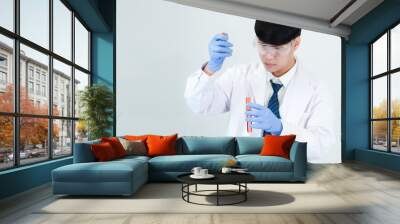 Portrait asian man student scientist or doctor look hand holding reagent mixing laboratory in science research laboratory with test tubes of various size in  laboratory chemistry lab white background Wall mural