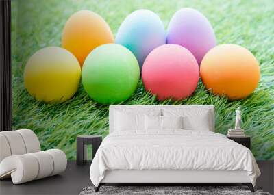 Colorful Easter eggs on green grass Wall mural