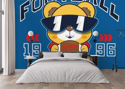 Teddy bear wearing sunglasses and holding american football ball and text born to win slogan on blue background illustration vector, Graphic t-shirts for kids. Wall mural