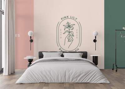 A set of beauty Studio logos in a minimalistic simple linear style. Vector emblems with a woman's hand and Lily flowers. Wall mural