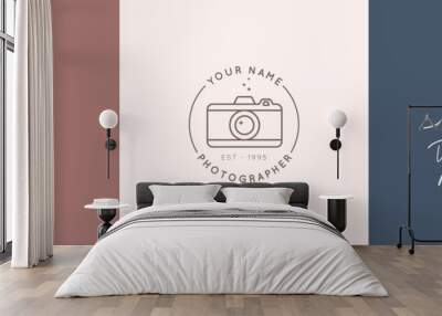 Linear logo of the photographer. Women's Hands hold the camera shutter. Vector logol for a photo Studio Wall mural