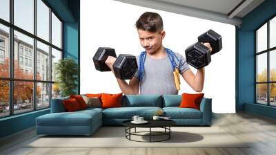 Concept of a healthy childhood. Adorable boy wants to be a macho man. Cute kid making funny faces while exercising with weights and jump rope isolated on white background Wall mural