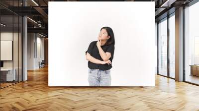 Young Asian woman doing thinking gesture wearing Black t-shirt and jeans isolated on white background Wall mural